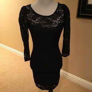 Black lace body hugging dress Very complimentary.